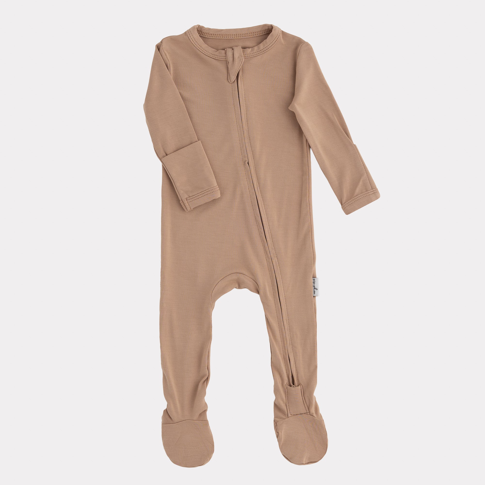 Beige baby onesie with a zipper on a white background