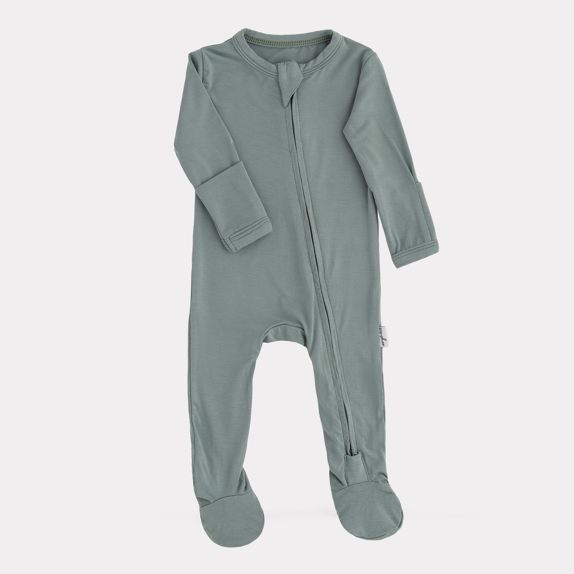 Green baby onesie with a zipper on a white background